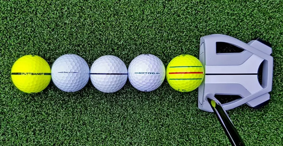 The Best marker for golf balls shown with example lines drawn on a golf ball to help with alignment and direction
